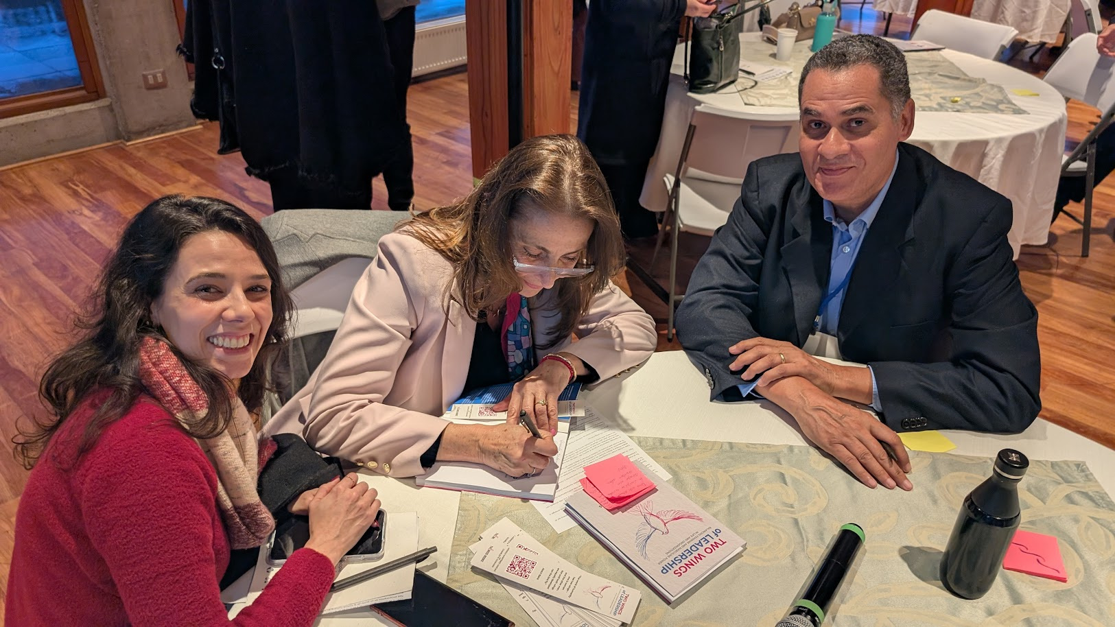 Authors signing books at a table